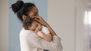 A mother holds her baby diagnosed with cerebral palsy. A cerebral palsy lawyer will help them file for compensation.