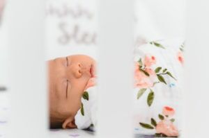 sleeping baby in flowered blanket