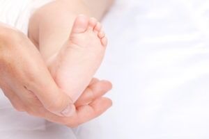close-up-of-baby-holding-mother’s-finger