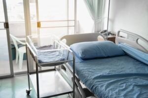 Empty Hospital Room With Baby Bassinet