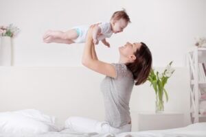 A mother is playing with a baby diagnosed with cerebral palsy. A cerebral palsy lawyer can help file for compensation to cover medical expenses and more.